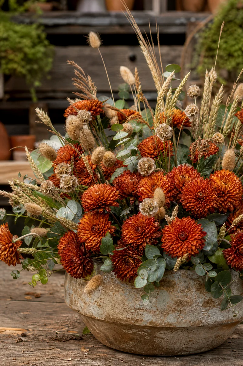 Mum and Dried Grass Planter Rust mums with dried wheat, bunny-tail grass, seed heads, and eucalyptus